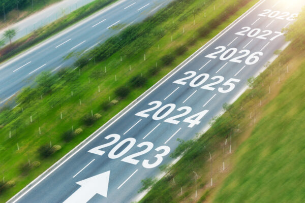 Top view of empty asphalt road with numbers 2023, 2024 to 2028
